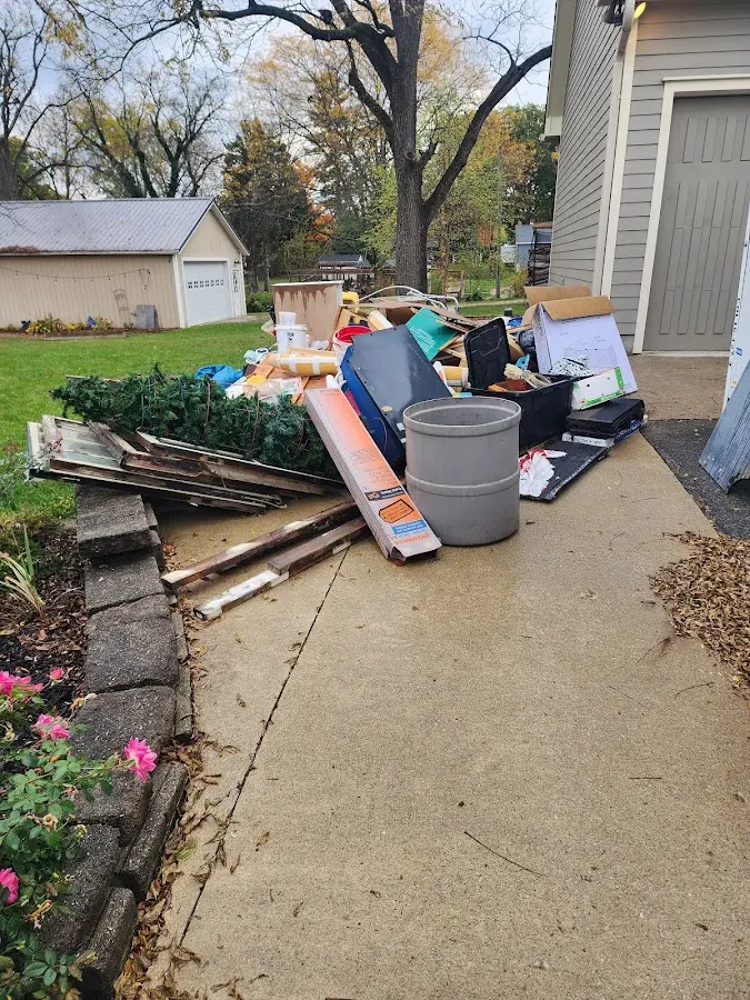 Dumpster being loaded with debris for Commercial Dumpster Rental in Cottonwood Heights